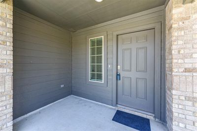 Covered entryway with enpugh space for a chair and side table to enjoy your morning coffee. | Image 3