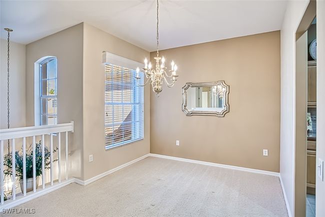 Carpeted empty room with an inviting chandelier | Image 10