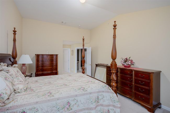 Carpeted bedroom with vaulted ceiling | Image 22