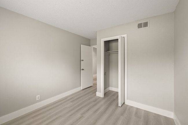 Unfurnished bedroom featuring light wood-style flooring and a closet | Image 19