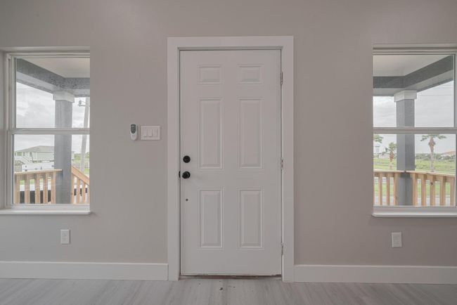 Looking inward from the front door, the layout opens directly into the heart of the home—welcoming you into the bright and airy shared living space. | Image 6