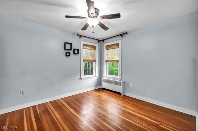 Unfurnished bedroom with a closet, hardwood flooring, and ceiling fan | Image 26
