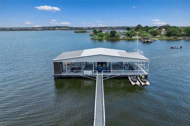 Dock area featuring boat lift and a water view | Image 40