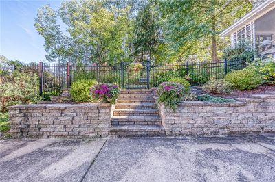 Enter through the lovely iron garden gate with a wider gate on the left side for a lawnmower. | Image 3