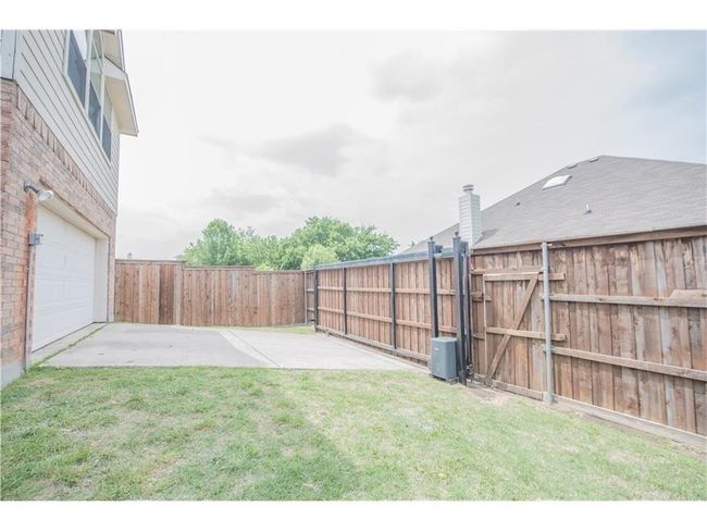 View of yard with a patio, a garage, and a gate | Image 23