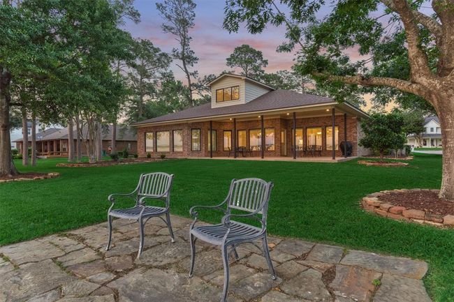 The back of the home is beautifully lit at night, creating a warm and inviting ambiance. The landscape has been professionally graded for optimal drainage, and an eight-zone sprinkler system—sprinkler controller enclosure is pre wired for cat 6 future sprinkler controller—ensures the lush greenery stays perfectly watered year-round. | Image 41