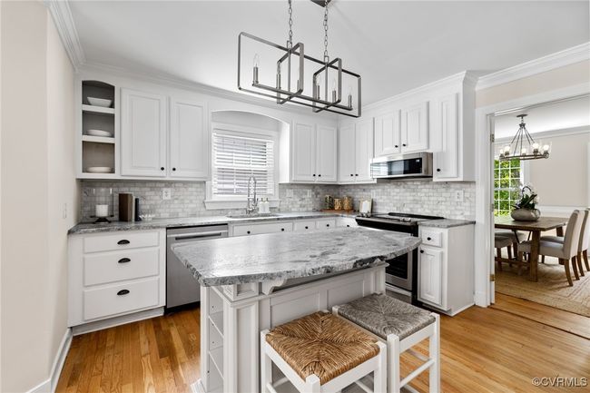 Another picture of the Kitchen showing the nice sized island offering storage and shelving on each end. | Image 14