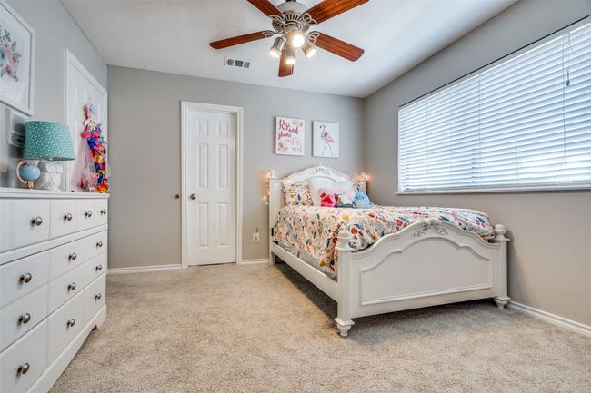 Bedroom with light carpet, baseboards, and ceiling fan | Image 29