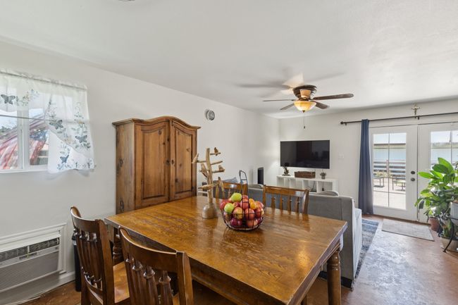 Mother in Law Suite Dining space with healthy amount of natural light, a ceiling fan, concrete flooring, and a wall mounted AC | Image 19
