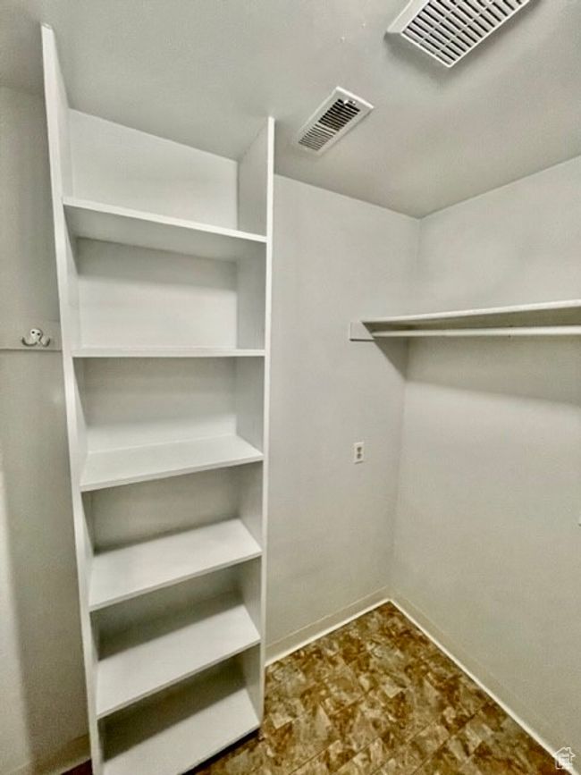 Spacious closet with visible vents | Image 16
