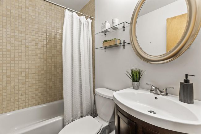 Main level primary bath situated between the primary bedroom and flex room | Image 23