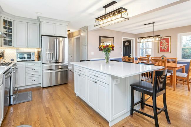 Updated stainless steel GE Profile appliances, ample counter space and pantry cabinet make this kitchen a pleasure in which to cook. | Image 5
