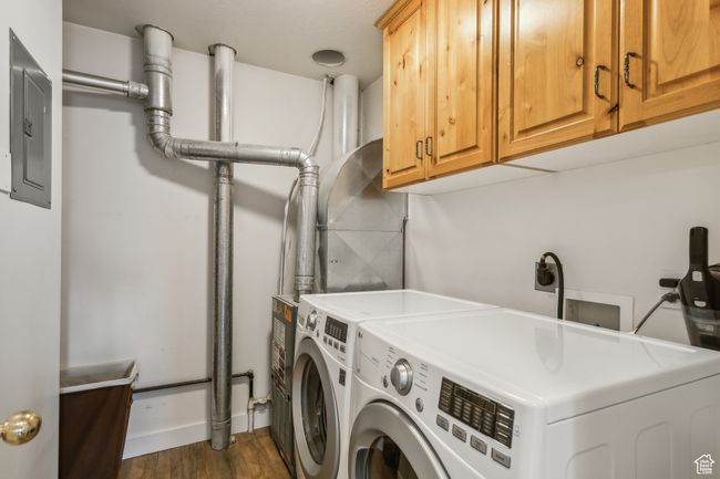 Washroom with washer and dryer, cabinet space, electric panel, and wood finished floors | Image 23