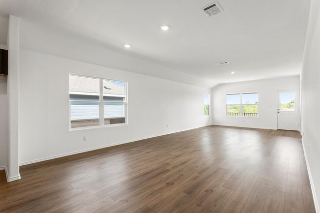 Spare room featuring dark wood-style flooring, recessed lighting, and vaulted ceiling | Image 11