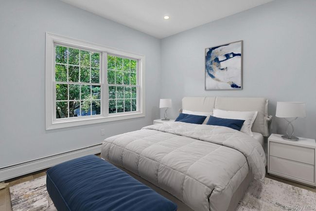 Bedroom featuring a baseboard radiator, recessed lighting, and wood finished floors | Image 15