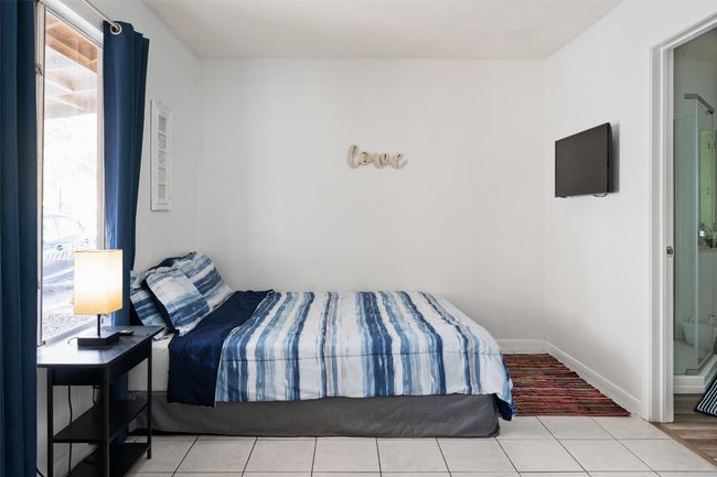 Bedroom featuring multiple windows and tile patterned floors | Image 6