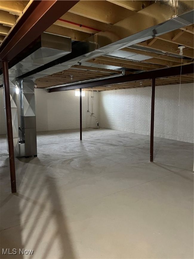 Unfinished below grade area featuring heating unit | Image 16