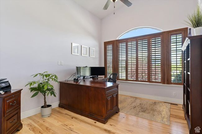 Office featuring light wood-style floors, a ceiling fan, and baseboards | Image 25