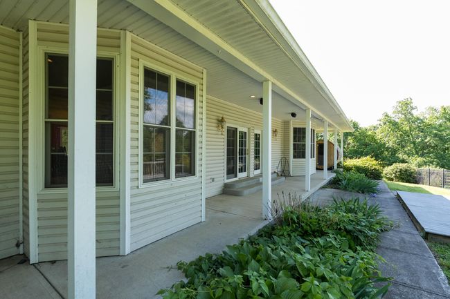 Covered Walkout at back of home to pool area. | Image 29
