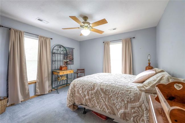 Bedroom featuring carpet, multiple windows, and a ceiling fan | Image 30