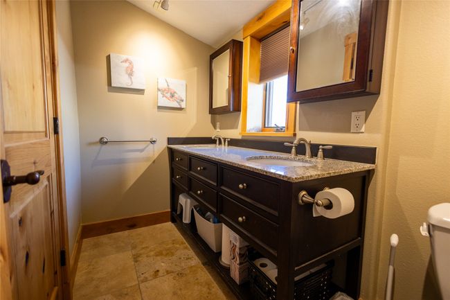 Full bath featuring double vanity and stone finish floors | Image 21