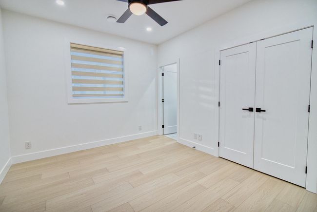 Unfurnished bedroom featuring light wood-type flooring, baseboards, recessed lighting, and ceiling fan | Image 14