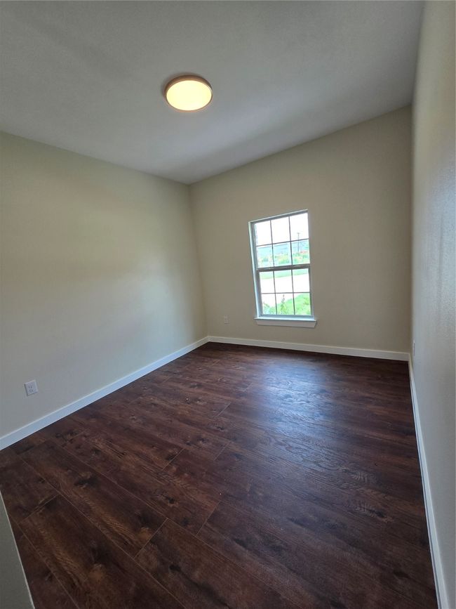 Spare room with dark wood-style floors and baseboards | Image 16