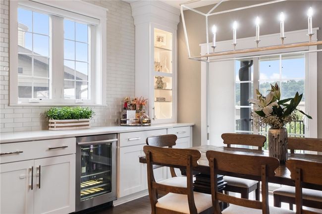Dining area with beverage bar and sliding glass door to rear covered deck. | Image 15