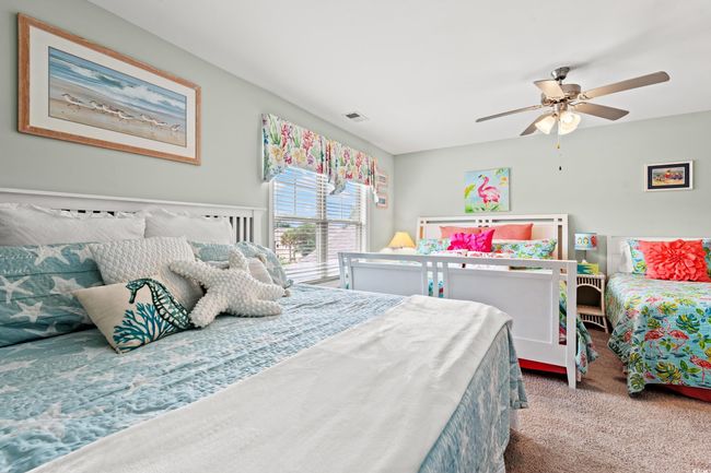 Carpeted bedroom featuring ceiling fan | Image 25