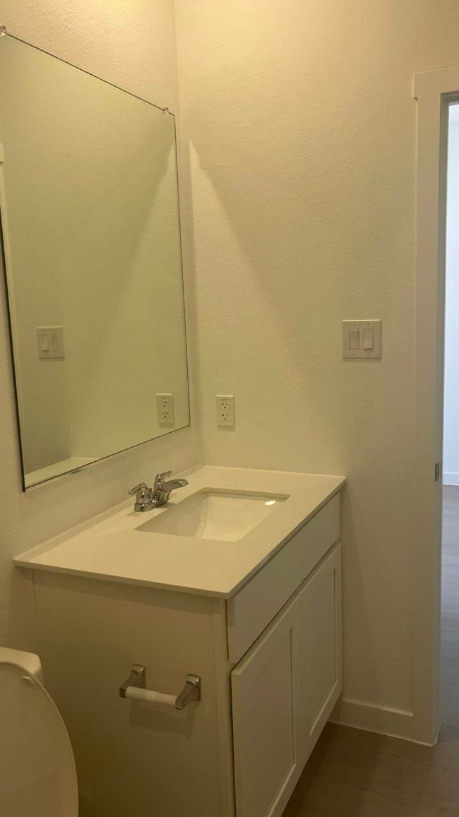 Half bathroom with vanity and baseboards | Image 6