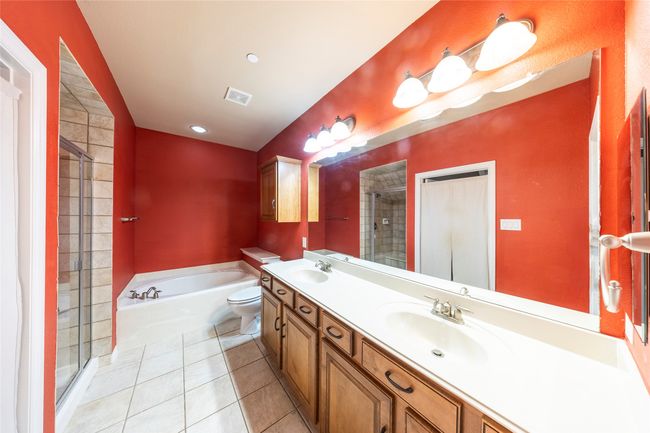 Full bath with a bath, double vanity, a stall shower, and tile patterned floors | Image 20