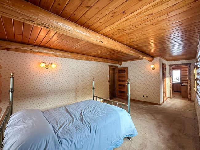 Carpeted bedroom featuring beamed ceiling and wood ceiling | Image 40