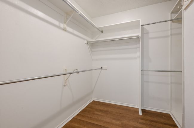 Walk in closet with dark wood-style flooring | Image 21