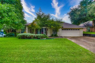 View of front of house featuring a front yard and a garage | Image 2