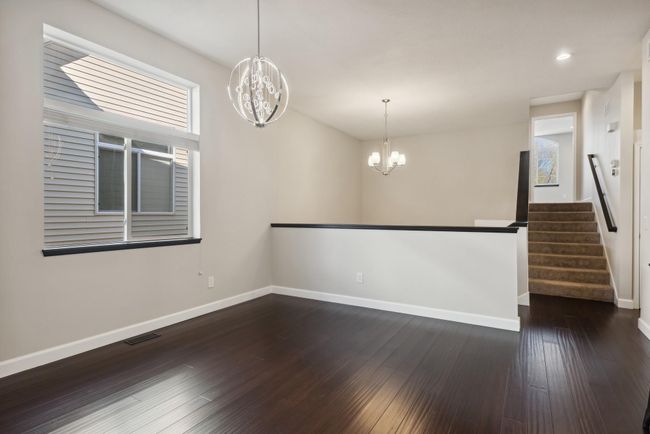 This is the dining space on the main level. Clean, crisp, fresh paint, and gorgeous modern chandelier! | Image 17