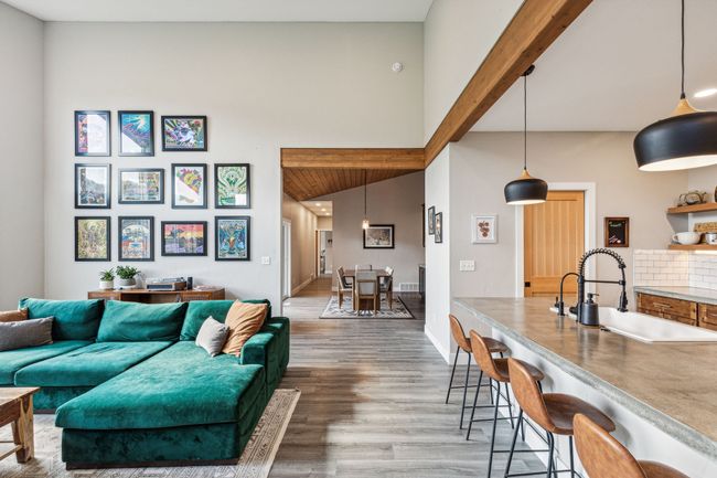 Living area featuring wood finished floors, baseboards, and vaulted ceiling | Image 18