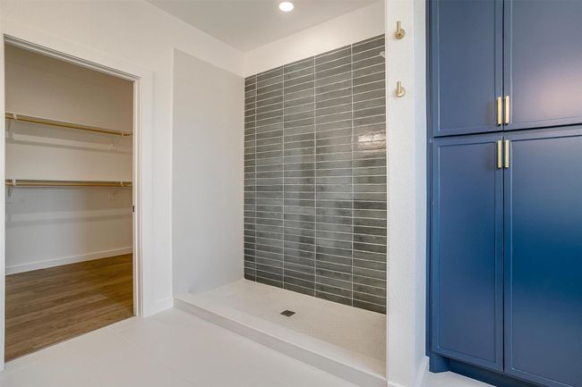 Full bathroom featuring a shower stall, tile patterned flooring, and recessed lighting | Image 21