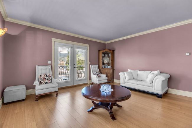 Living area with french doors, crown molding, wood finished floors, and baseboards | Image 8