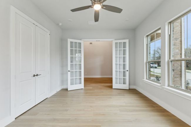 Spare room with french doors, light wood-style floors, and ceiling fan | Image 7