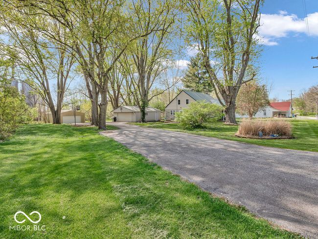 view of front facade with a garage and a front lawn | Image 32
