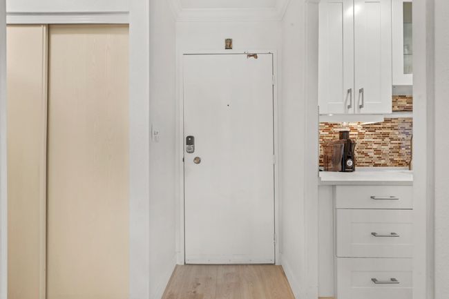Doorway with crown molding and light wood-style flooring | Image 23