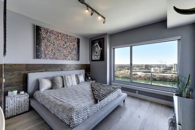 Bedroom featuring track lighting, wood finished floors, and baseboards | Image 5