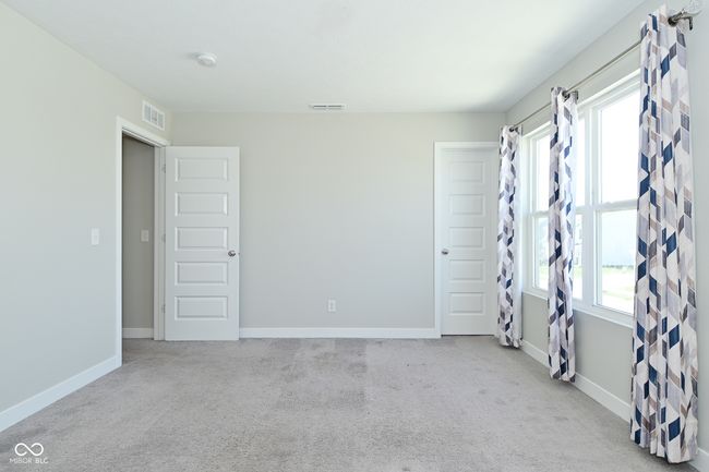 carpeted empty room featuring visible vents and baseboards | Image 29