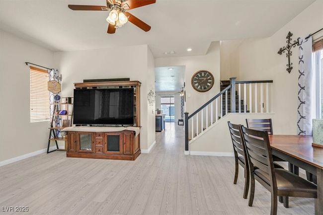 Living area with baseboards, recessed lighting, ceiling fan, stairs, and light wood-type flooring | Image 9