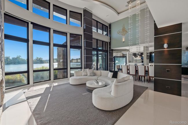 Community lobby featuring a water view and a towering ceiling | Image 4