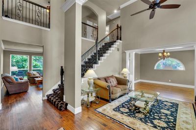 Formal Living features a 20-ft entry, triple stacked crown molding, handscraped hardwood flooring and open views to the front half of the first floor. | Image 3