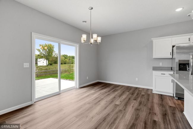 (Photo of previously finished home) Spacious dining room that opens up to a large 14x14ft slab in the backyard, ideal for outdoor entertaining. | Image 10