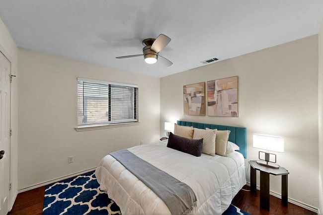 Bedroom with wood finished floors and ceiling fan | Image 22