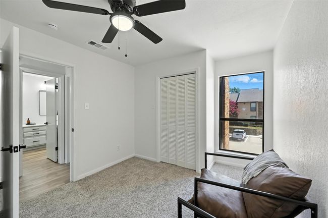 Sitting room with light carpet and ceiling fan | Image 26