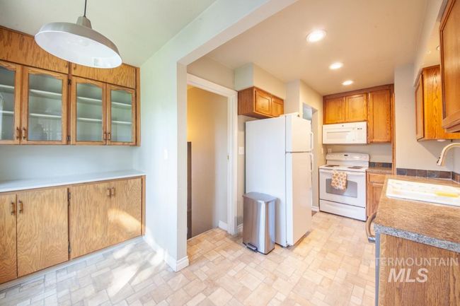 Kitchen featuring white appliances, recessed lighting, and glass insert cabinets | Image 5